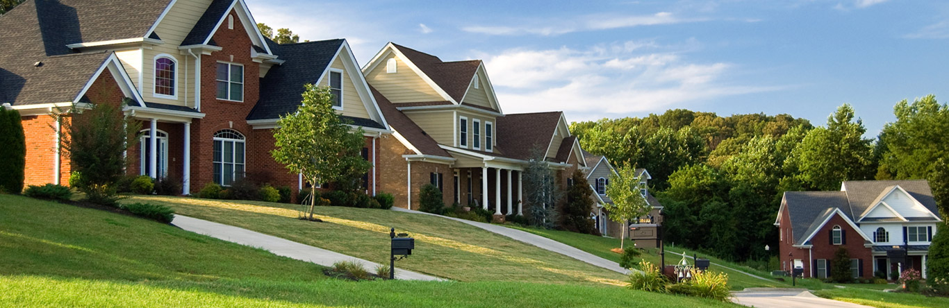 3 homes along tree lines with well manicured lawns